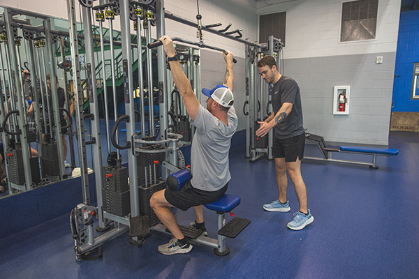 Personal Trainer assisting a student.