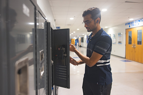 Student using RecWell lockers.