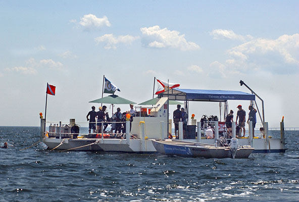 students working from a barge