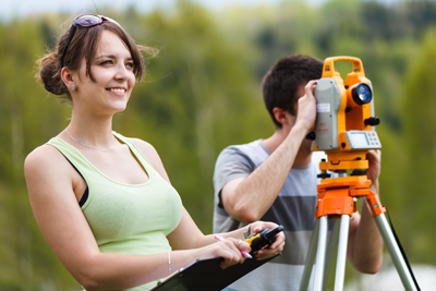 two students looking through mapping device