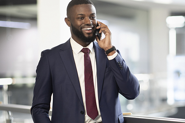 Sports manager in professional attire talking on a mobile phone.