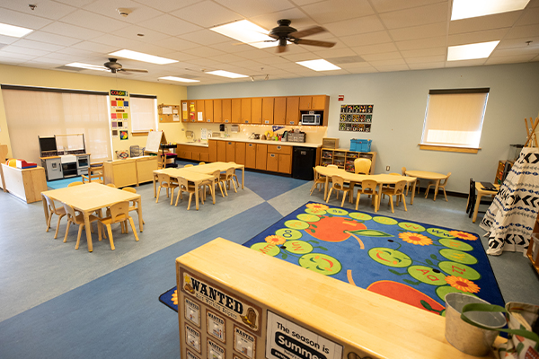 Classroom photo with tables and development toys